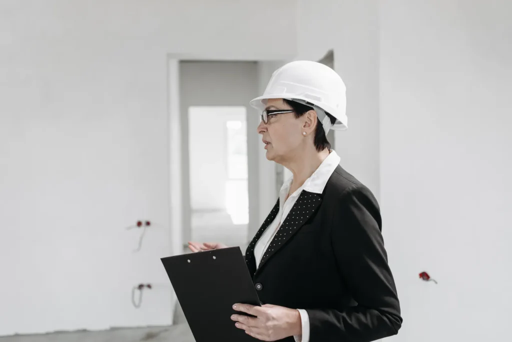 Engineer in a hard hat, the kind of licensed professional who performs Local Law 126 inspections