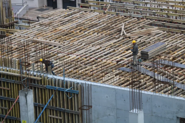 Construction workers carrying out concrete repair work on site