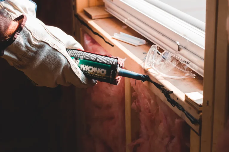 Worker applying sealant along a joint to keep water out
