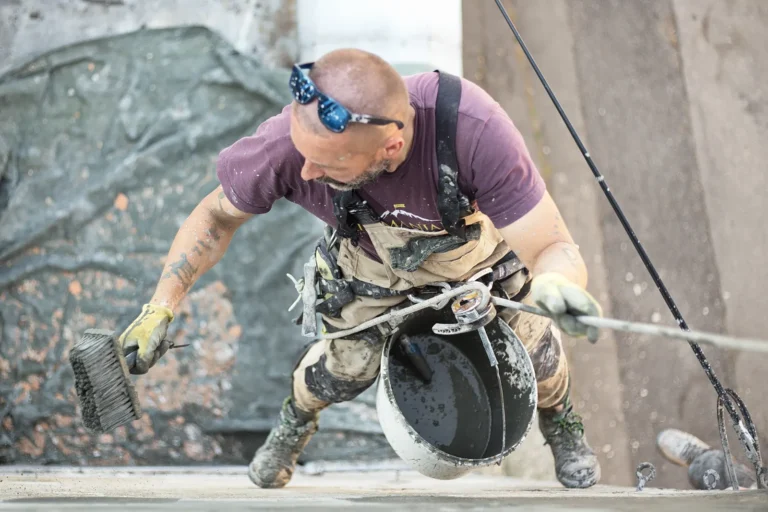 Worker applying a repair coat to a surface during SREM repair work